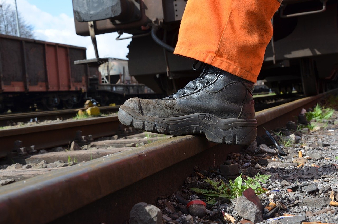 railroad track contractor with his boot on the railroad tracks