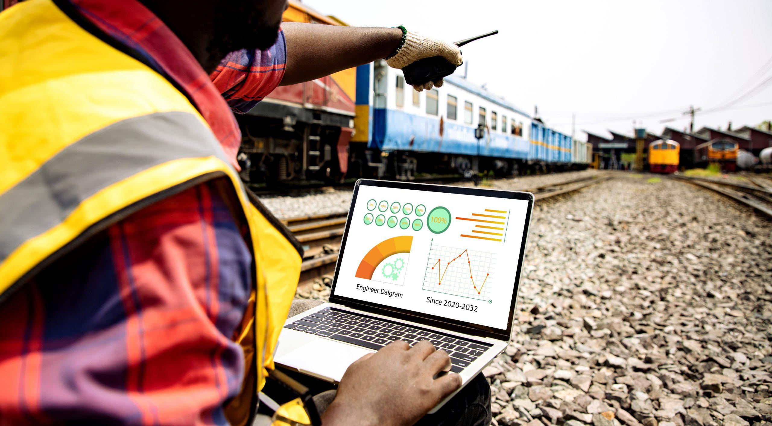 railroad worker reviewing railroad safety standards on a laptop